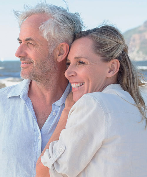 An older couple looking out over the ocean together